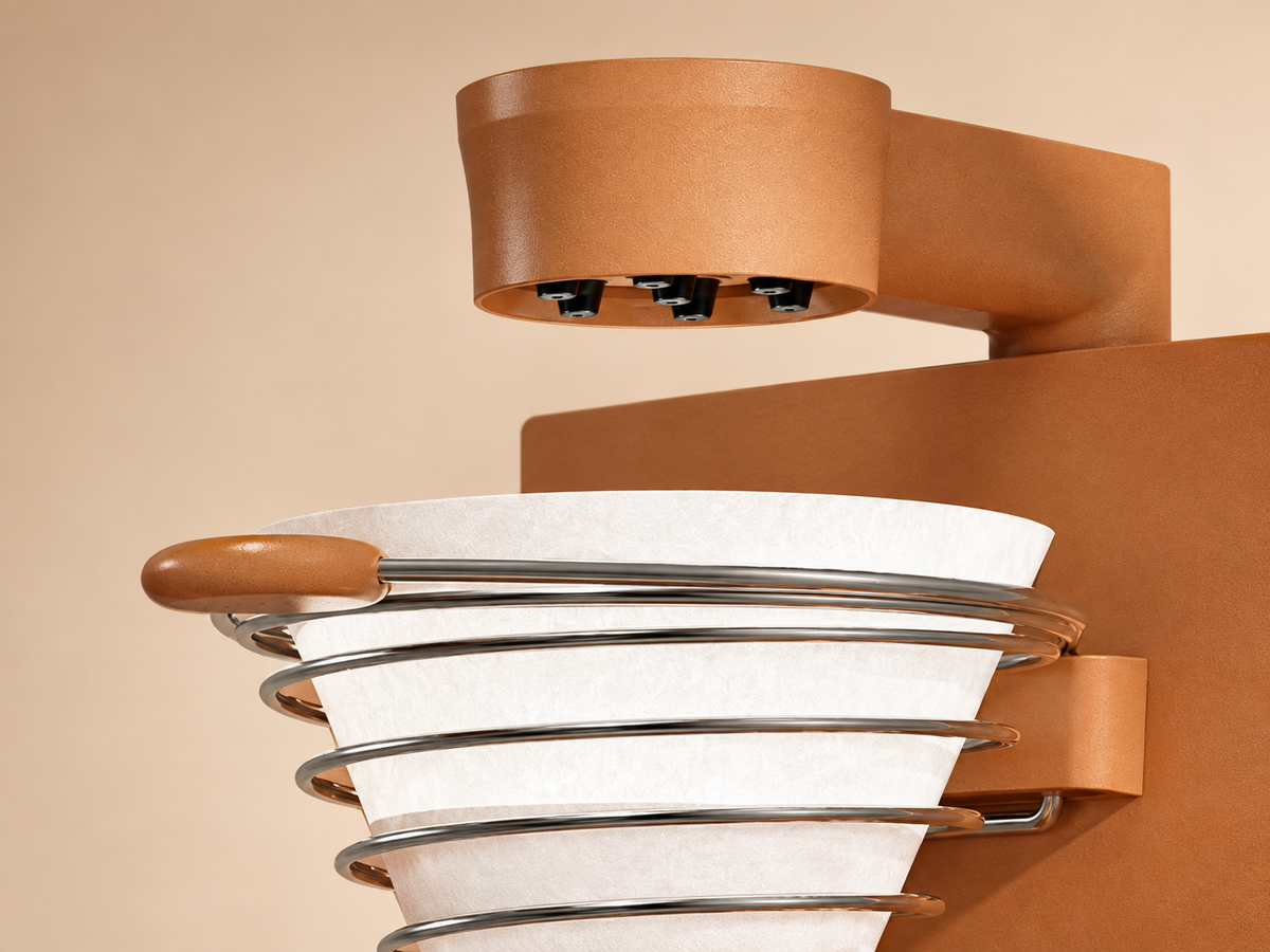 Close-up of the brown coffee maker showerhead and spiral filter holder